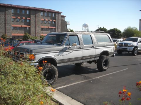 1990 Ford C-150 (Centurion Conversions) - This 1990 Ford C-150 Centurion Conversion SUV is parked in a lot with another vehicle behind it.