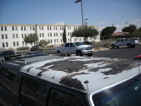 1990 Ford C-150 (Centurion Conversions) - The paint on this truck's roof is severely damaged and peeling, revealing darker material underneath.