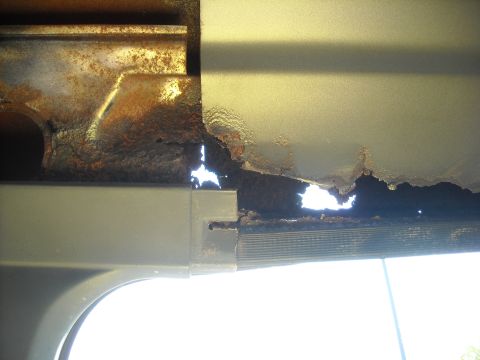 1990 Ford C-150 (Centurion Conversions) - Severe rust damage is visible on this metal panel, indicating significant deterioration.