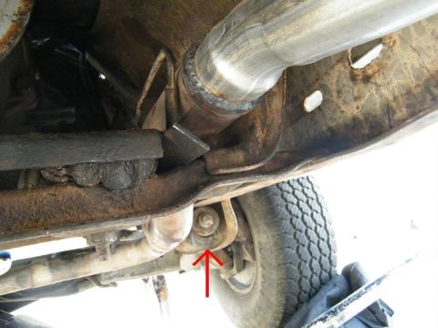 1982 Ford Bronco - Close-up of vehicle undercarriage showing exhaust system and suspension components.