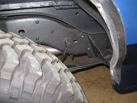 1990 Ford Bronco - Undercarriage view showing the frame and a tire. Year is not discernible.