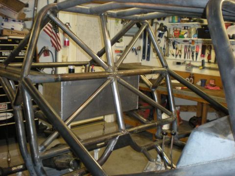 Suzuki Samurai - Interior view of a custom-built tube chassis vehicle, showing extensive roll cage construction and a central fuel tank.