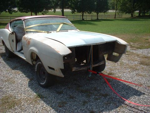 1969 Mercury Cyclone - This 1969 Mercury Cyclone shows significant wear and is missing its front-end components, secured by red tow straps.