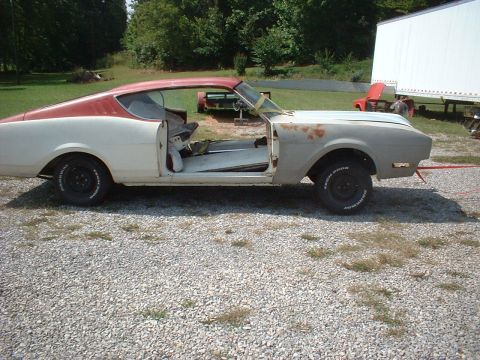 1969 Mercury Cyclone - This 1969 Mercury Cyclone is seen from the side, showing its two-tone paint scheme and open doors as it appears to be in the process of res…