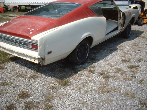 1969 Mercury Cyclone - Rear view of a 1969 Mercury Cyclone project car, showing its two-tone paint and missing body panels.