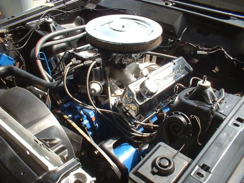 1970 Ford Torino - Close-up of a V8 engine bay with performance upgrades like chrome valve covers and an aftermarket air cleaner.