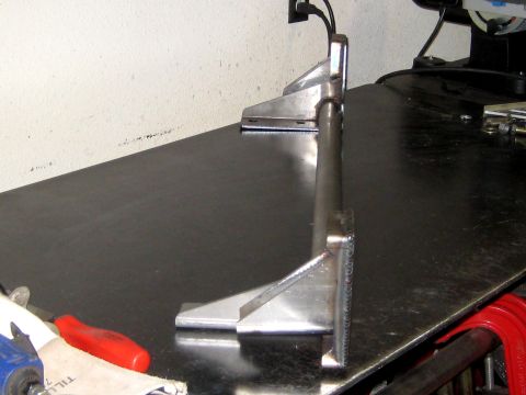1996 Ford Bronco - Metal bracket assembly on a workbench, possibly for automotive use.