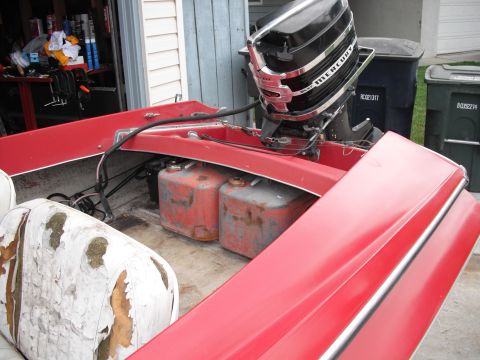 1991 Ford Bronco - Interior of a red boat with fuel tanks and outboard motor visible.