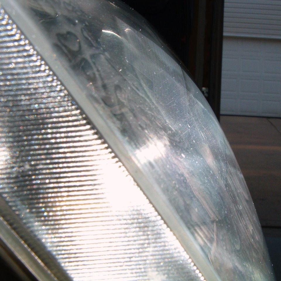 Macro of a headlight lens edge with fluted marker section and hazy scratched clear cover