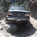 1989 Ford Bronco - This 1989 Ford Bronco is shown from the front, tackling a challenging rocky trail.