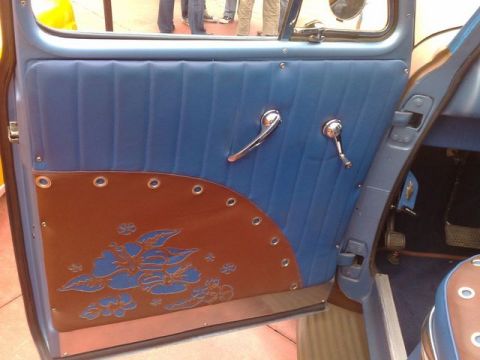 1991 Ford LTD Crown Victoria - Close-up of a car's interior door panel, showing blue upholstery and a decorative brown lower section.