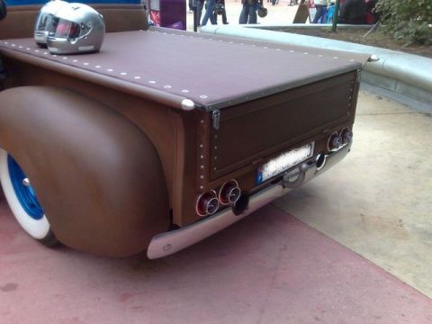 1991 Ford LTD Crown Victoria - A customized pickup truck bed is shown from the rear, a brown tonneau cover and chrome accents.