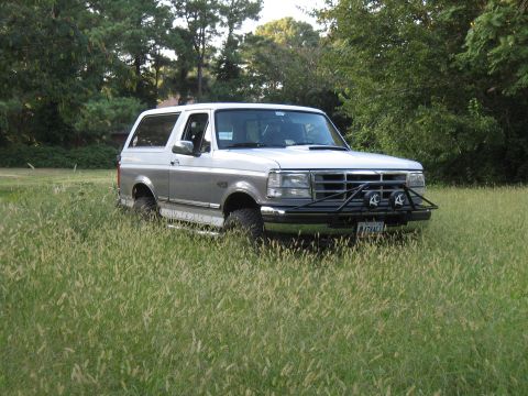 1994 Ford Bronco - This 1994 Ford Bronco is parked in a grassy field, a custom front bumper with KC lights.