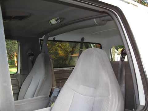 1994 Ford Bronco - View of the interior from the passenger side, looking towards the front seats and roll bar.