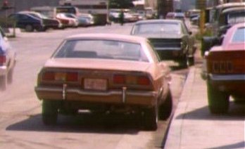 1978 Ford Mustang II - Rear view of a brown 1978 Ford Mustang II hatchback parked on a city street.