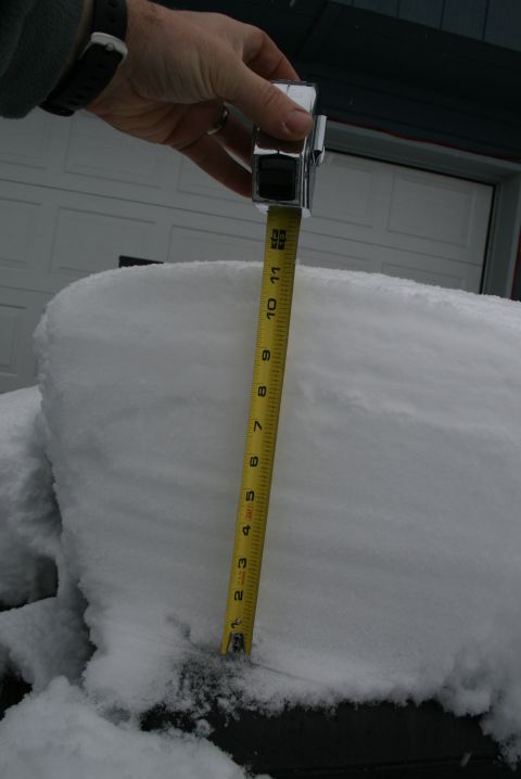 2003 Jeep TJ - A tape measure is used to measure snow depth, indicating approximately 10 inches accumulated.