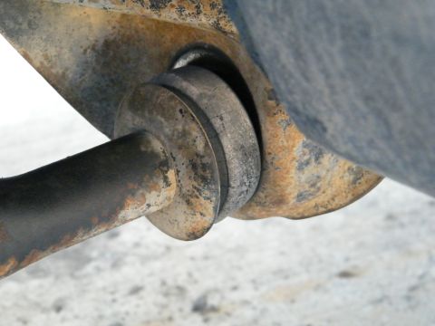 1982 Ford Bronco - Detail of a worn suspension part, showing rust and metal fatigue.