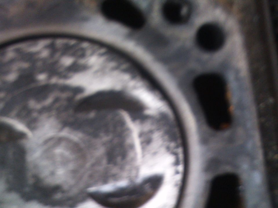Close-up of an engine cylinder with piston visible inside