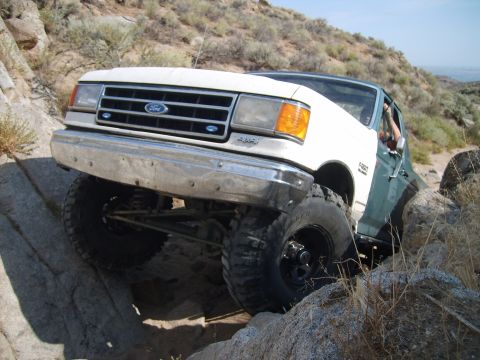 1989 Ford Bronco - This Ford Bronco navigates a rocky trail, demonstrating its off-road capabilities.