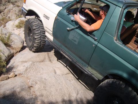 1989 Ford Bronco - Ford F-250 off-road on rocky terrain. The vehicle appears to be a 1989 model.