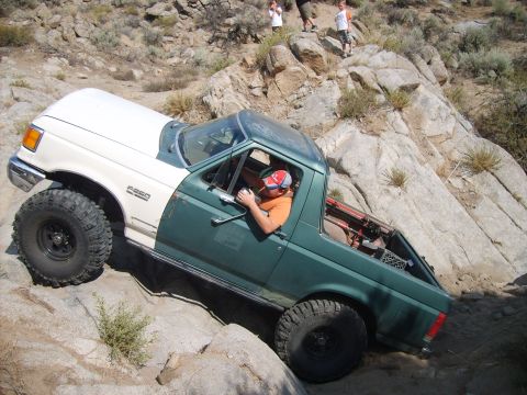 1989 Ford Bronco - This modified SUV navigates a rocky trail, its off-road capabilities.