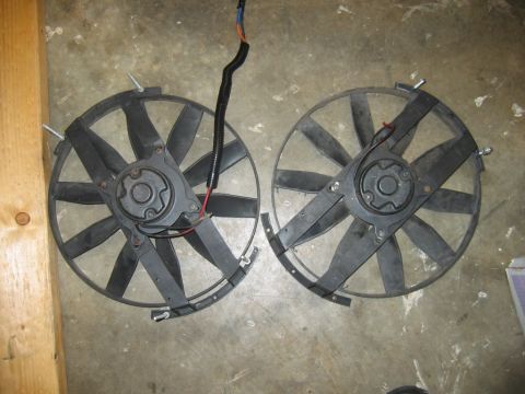 1992 Ford Mustang - Two radiator fans are shown from a top-down perspective on a concrete surface.