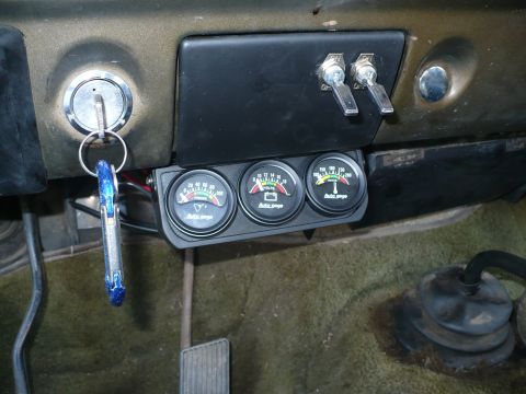1979 Ford Bronco - Basic small engine temp, volts and oil pressure gauges. Just big enough so I can kep an eye on things. One switch is the cut off for the re…