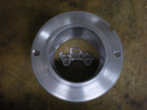 Suzuki Samurai - A metal part features a silhouette of a Suzuki Samurai with 'ZOR' visible on its side.