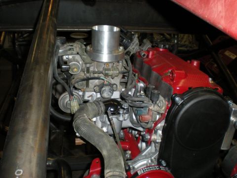 Suzuki Samurai - Close-up view of an engine bay, focusing on the carburetor and associated components.