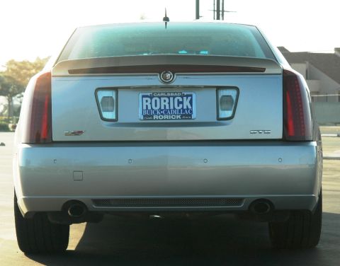 2006 Cadillac STS - The rear of a silver 2006 Cadillac STS sedan is shown, displaying its taillights, dual exhaust, and a California license plate.
