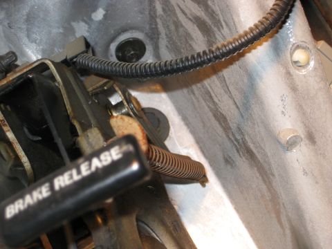 1995 Ford Bronco - Close-up view of a brake release lever and its associated spring.
