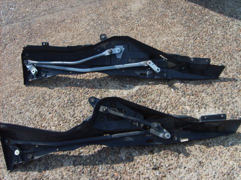 1993 Ford Crown Victoria - Two cowl panels with windshield wiper mechanisms are shown laid out on the ground.