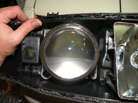 1998 Subaru Legacy - Close-up of a vehicle's headlight assembly, showing the lens and internal components.