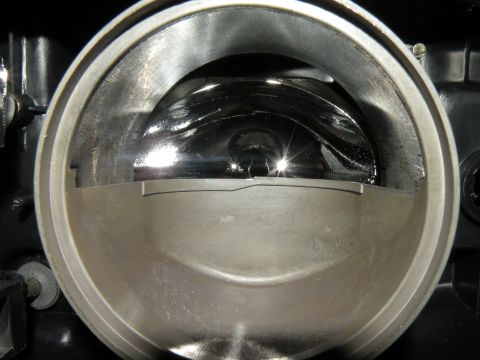 1998 Subaru Legacy - Close-up view of a vehicle's headlight assembly, showing the reflector and housing components.