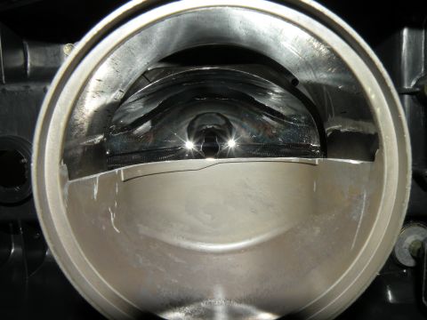 1998 Subaru Legacy - Interior view of a throttle body, showing the butterfly valve mechanism and intake tract.