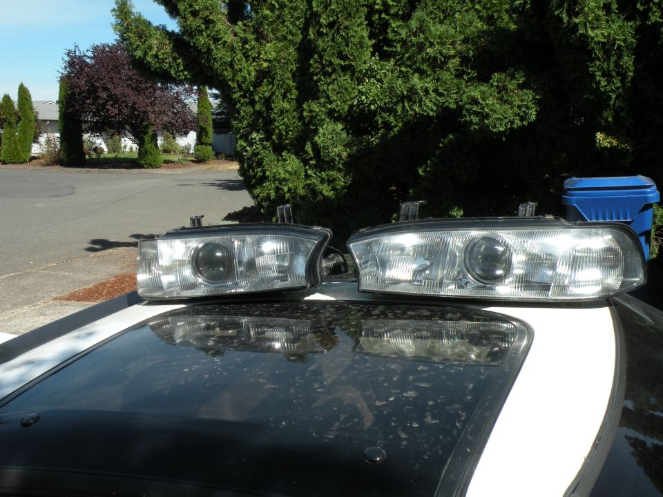 Two car headlights resting on a car's roof