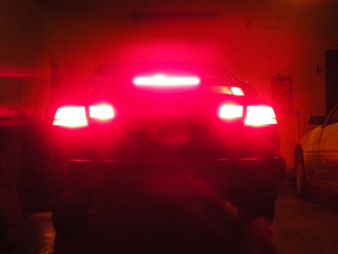 1998 Subaru Legacy - Car's brake lights are on, showing the rear of the vehicle and another car nearby.