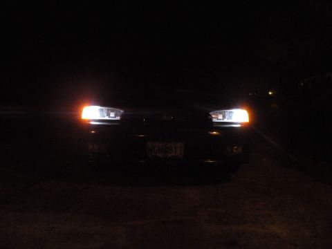1998 Subaru Legacy - Front view of a 1998 Subaru Legacy at night with headlights illuminated.