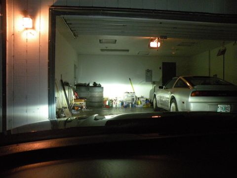 1998 Subaru Legacy - A silver coupe is parked inside a garage, with its rear facing the camera. The license plate is clearly visible.
