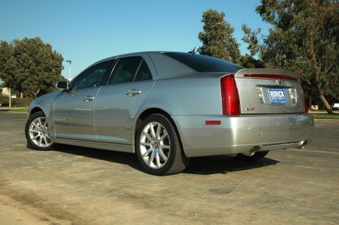 2006 Cadillac STS - Rear 3/4 view of a silver 2006 Cadillac STS sedan, showing its distinctive taillights and spoiler.