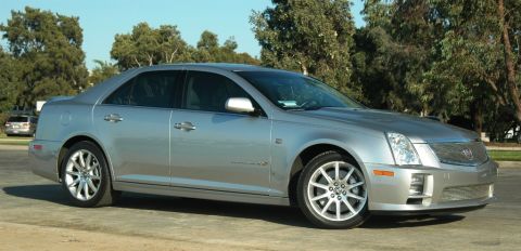 2006 Cadillac STS - A silver 2006 Cadillac STS sedan is parked on a paved surface with trees in the background.