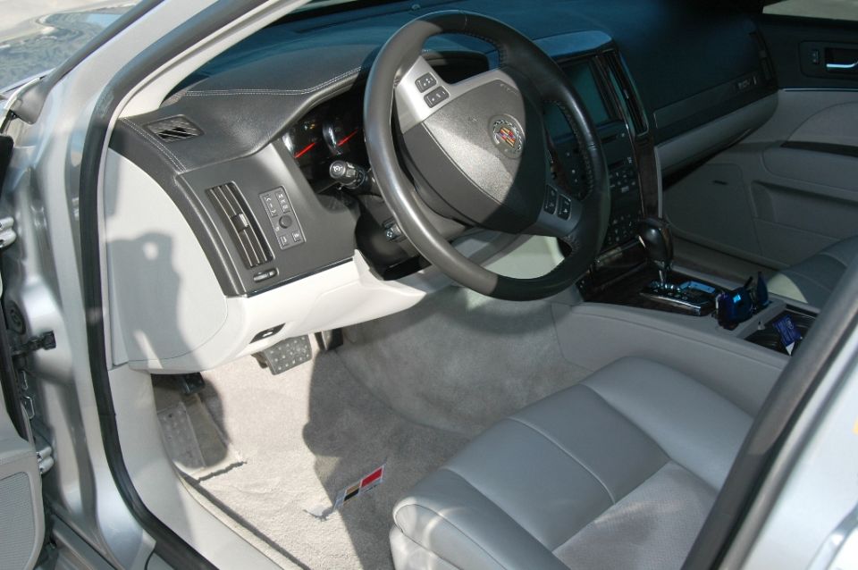 Cadillac STS interior with gray leather seats, wood console trim and alloy pedals