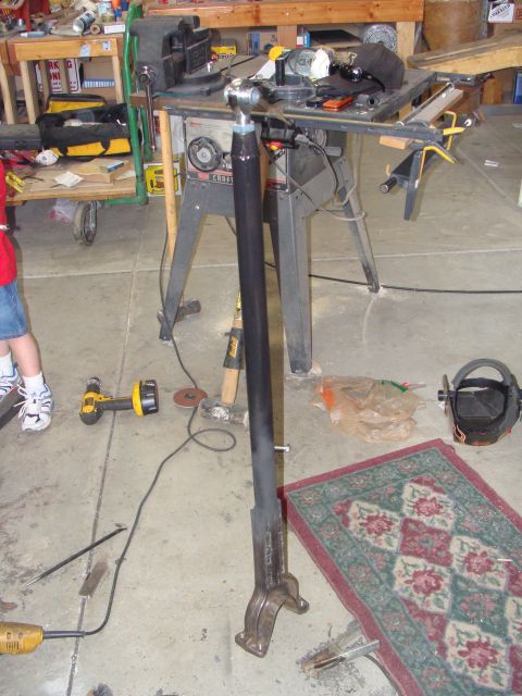 1993 Ford Bronco - A metal component is shown on a workbench with various tools and equipment in the background.