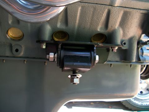 1996 Ford Bronco - Close-up of an engine mount bracket attached to an engine block.