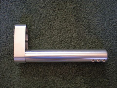 1973 Ford F-100 - This is a close-up of an aluminum part with visible screws, placed on a carpeted surface.