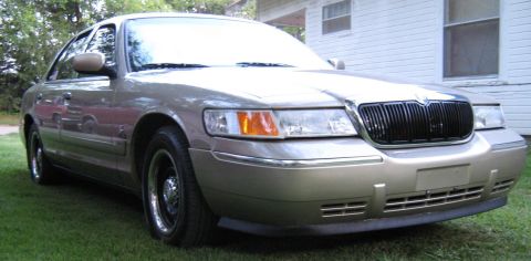 2000 Mercury Grand Marquis - This 2000 Mercury Grand Marquis is shown in a three-quarter front view, parked on a grassy lawn.