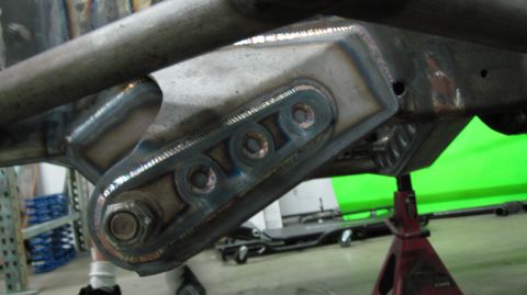 1995 Ford Bronco - Custom suspension bracket with adjustable mounting points, likely for off-road modification.