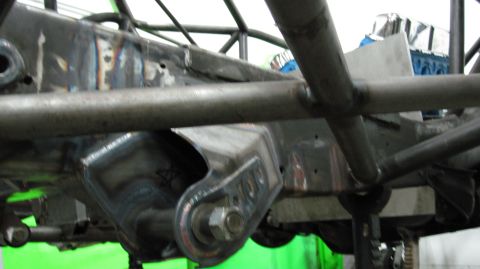 1995 Ford Bronco - The photo shows custom suspension parts and frame modifications, not a complete vehicle.