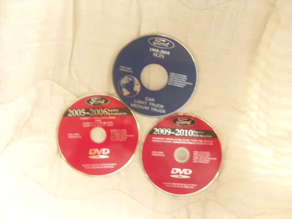 Photo of three Ford service information DVDs spread on a surface