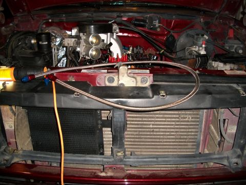 1996 Ford Bronco - Engine bay of a 1996 Ford Bronco showing aftermarket intake and fuel lines.